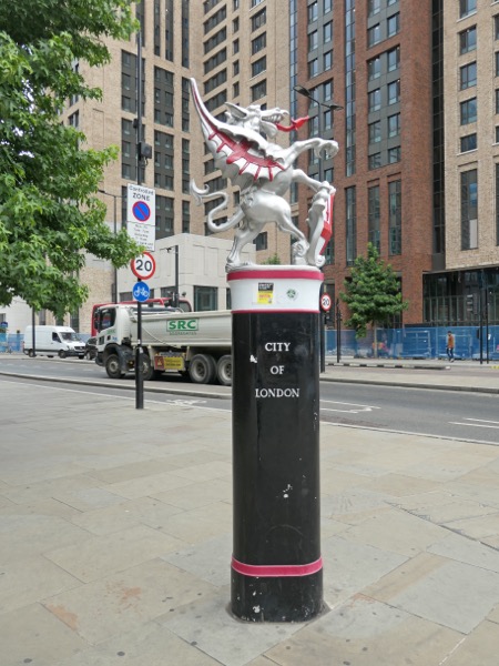 A City of London boundary dragon clutching a shield at Aldgate — one of fourteen silver dragons marking the Square Mile's jurisdictional perimeter
