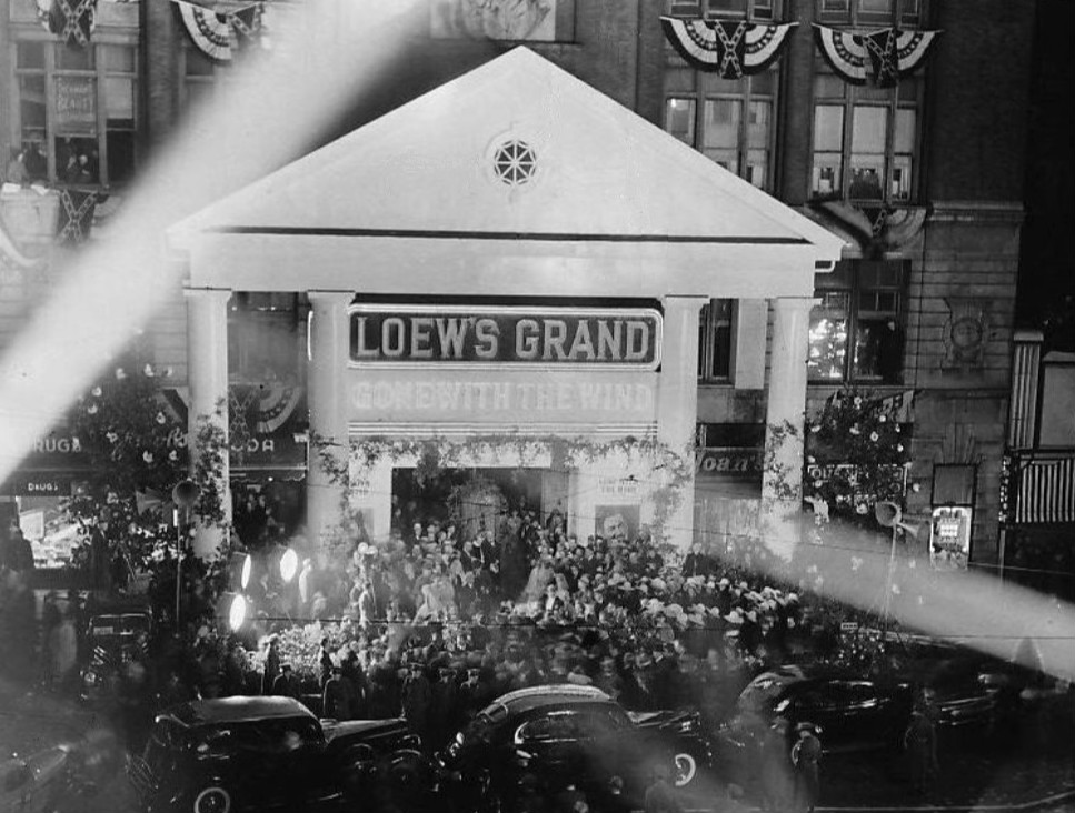 Crowds gathered outside Loew's Grand Theatre in Atlanta, Georgia for the world premiere of Gone with the Wind on December 15, 1939 — the theater's facade transformed with Southern plantation columns and floral garlands
